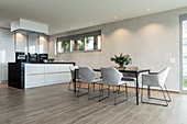 Minimalist kitchen-dining room in grey and beige
