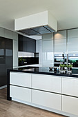 Modern, black-and-white kitchen with glossy cabinets