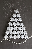 Christmas tree made from 3D origami stars on grey linen fabric