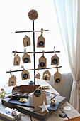 Advent calendar handcrafted from twigs and paper houses