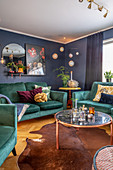 Teal sofa set in interior with blue walls