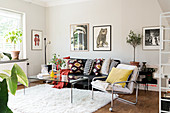 Colourful scatter cushions on leather sofa and armchair in living room