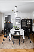 Black chairs around table in vintage-style dining room