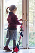 Girl hanging bunting in window