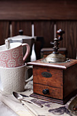 Vintage coffee mill and coffee mugs