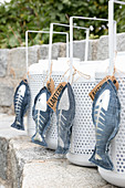 Hand-sewn denim fish ornaments with silver skeletons