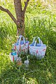 Hand-sewn picnic bags and cool bags on lawn