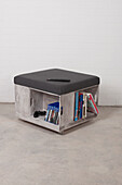 Wooden stool with storage space for books and games console