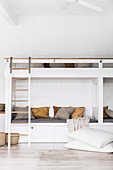 Bunk beds in the room with white wood paneling