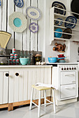 Vintage kitchen with plate rack and decorative wall plates on wall