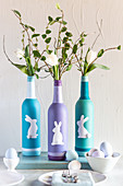 Painted bottles decorated with Easter bunnies and used as vases
