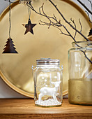 White deer figurine in jar in front of gold tray