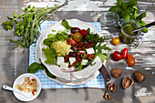 Millet salad with pesto, rocket, spinach, tomatoes and feta