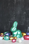 Chocolate bunny and eggs wrapped in colourful shiny foil