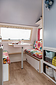 Retro-style floral couches in renovated 80s caravan