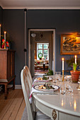 White, Georgian dining table in interior with grey-blue walls