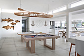 Pool table in large, open-plan interior with maritime accessories
