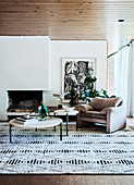 Round coffee table, armchair and graphically patterned carpet