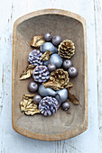 Fruits, pine cones and leaves dipped in coloured wax or sprayed gold