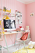 Desk in feminine room with pink walls
