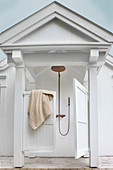 Outdoor shower with saloon doors and porch roof