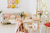 In Pastelltönen festlich dekoriertes Wohnzimmer mit gedecktem Partytisch