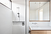 Clear lines and square mirror in modern bathroom
