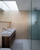 Small, modern bathroom with wood-clad walls