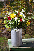 Natural spring bouquet in old metal jug