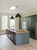 Island counter in elegant kitchen with grey furnishings