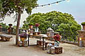 Table, lanterns, hydrangeas in demijohns and wooden crates
