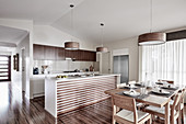 Dining area and kitchen island in open-plan interior