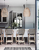Rattan bar stools at the counter in a classic grey kitchen