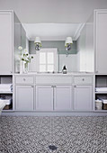 Built-in wardrobe with coffered fronts in a classic bathroom in grey tones