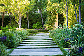 Path of large flagstones through summer garden