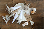 Cones decorated with frills and fabric Easter bunny on chopping board
