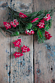 Numbered Christmas trees made from red felt and conifer twigs