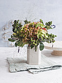 Autumn bouquet with hydrangea flowers, witchgrass, and tufts of unripe olives