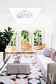 Lounge with slipcover furniture, tiled floors and French doors, Byron Bay, New South Wales, Australia