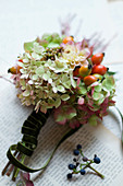 Small bouquet made of hydrangea flowers, rose hips and dahlia