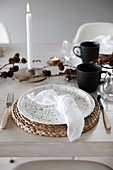 Place setting with Christmas decorations on wooden table