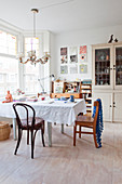 Eclectic vintage dining room with plywood floor