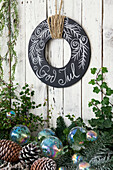 Alternative Advent wreath made of black painted wooden board with chalk drawing