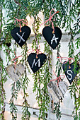 DIY hearts made of wood and cardboard with 'XMAS' lettering