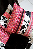 Homemade pillow with pink and black patterned fabrics