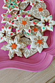 Artfully decorated cookies on a pink tray