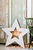 DIY star made of plywood wrapped with fairy lights