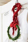 DIY wreath made of pine branches with red felt wool