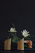 Chrysanthemums (Chrysanthemum) in bamboo vases and Buddha head