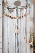 Christmas decorations on old wooden door with peeling paint